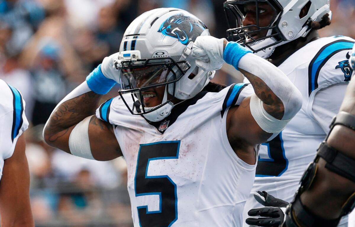 Carolina Panthers running back Rico Dowdle celebrates after scoring against the Miami Dolphins during the second half of an NFL football game, Sunday, Oct. 5, 2025, in Charlotte, N.C. (AP Photo/Jacob Kupferman)