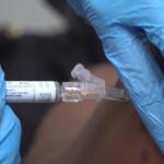 A pharmacist gives a patient a flu shot in Miami on Sept. 9, 2025. (AP Photo/Daniel Kozin)