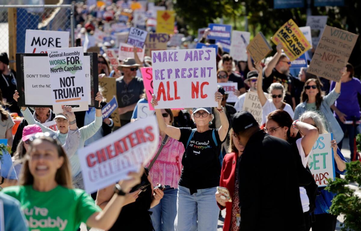 Marchers proceed from the Capitol during a rally protesting a proposed redistricting map Tuesday, Oct. 21, 2025, in Raleigh, N.C. (AP Photo/Chris Seward)