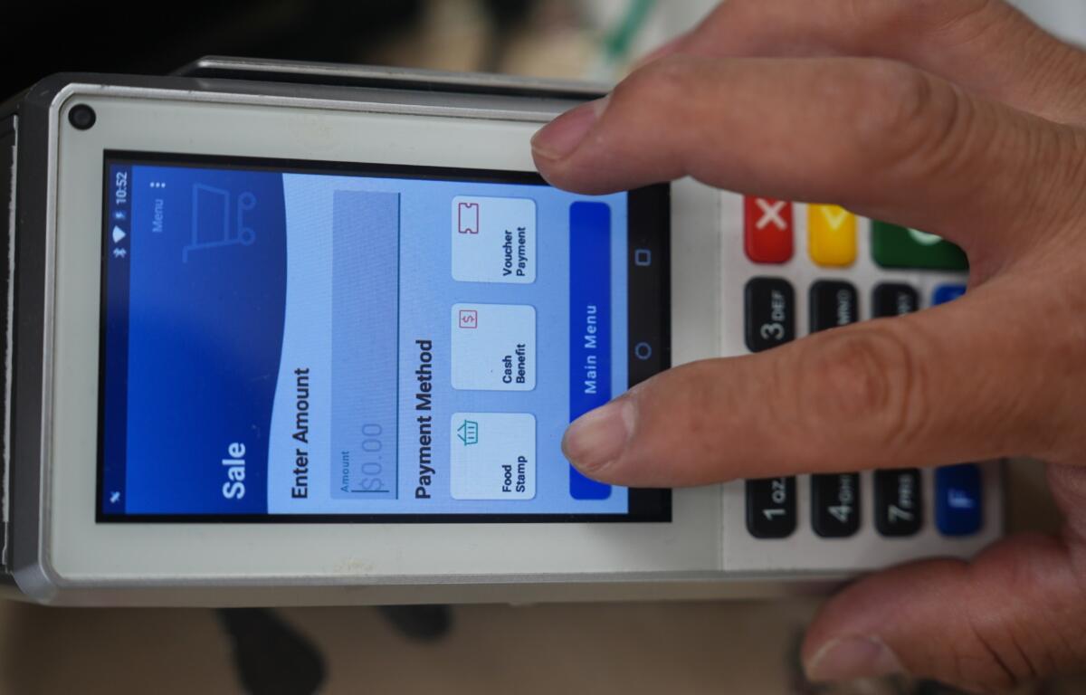 A shopper makes a purchase with food stamps on Monday, Oct. 27, 2025, in Los Angeles. (AP Photo/Damian Dovarganes)