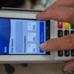 A shopper makes a purchase with food stamps on Monday, Oct. 27, 2025, in Los Angeles. (AP Photo/Damian Dovarganes)