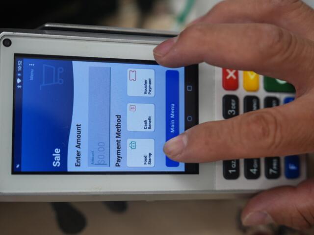 A shopper makes a purchase with food stamps on Monday, Oct. 27, 2025, in Los Angeles. (AP Photo/Damian Dovarganes)