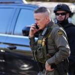 U.S. Border Patrol Commander at large Gregory Bovino takes a phone call, Monday, Nov. 17, 2025, in Charlotte, N.C. (AP Photo/Matt Kelley)
