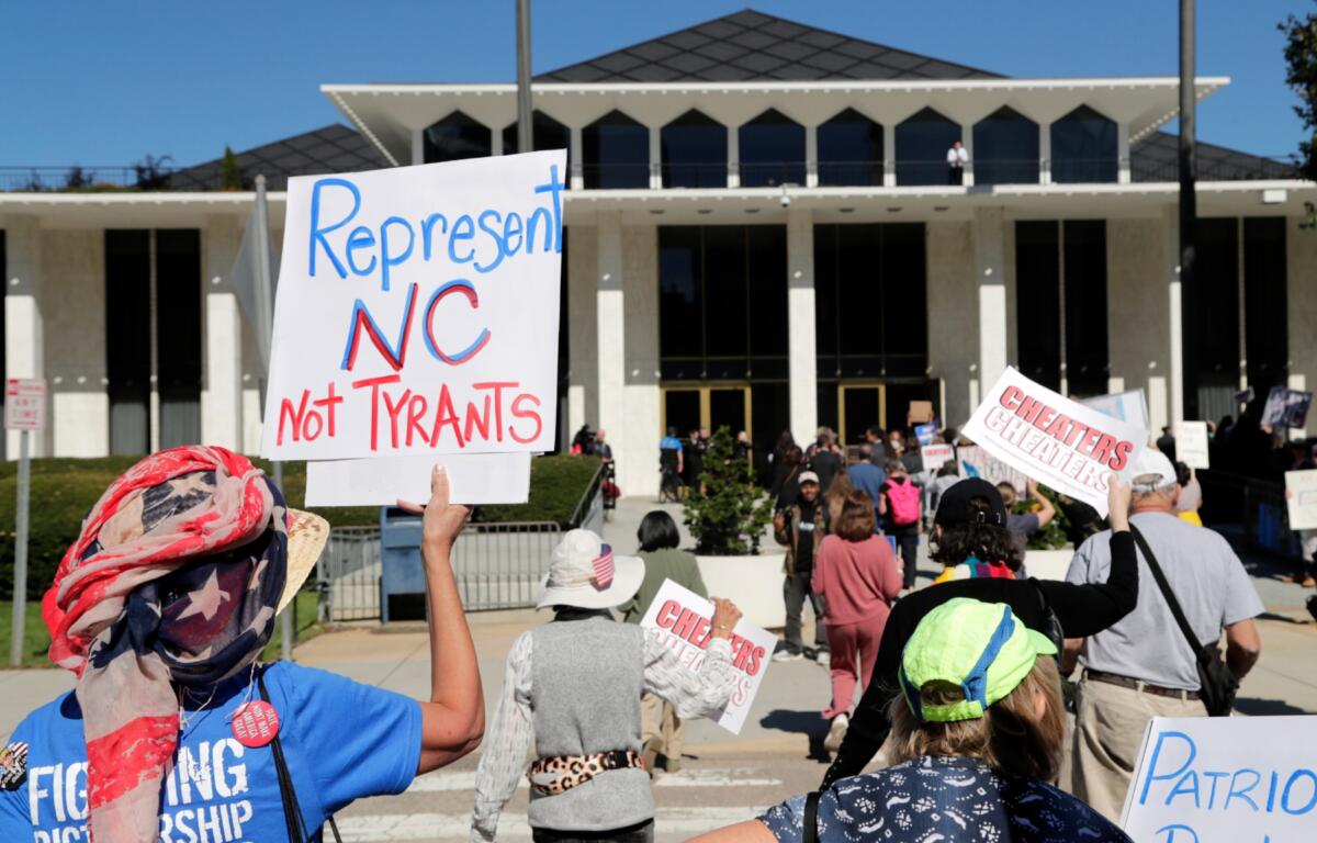 FILE - Demonstrators approach the Legislative Building during a rally protesting a proposed election redistricting map, Oct. 21, 2025, in Raleigh, N.C. (AP Photo/Chris Seward, File)