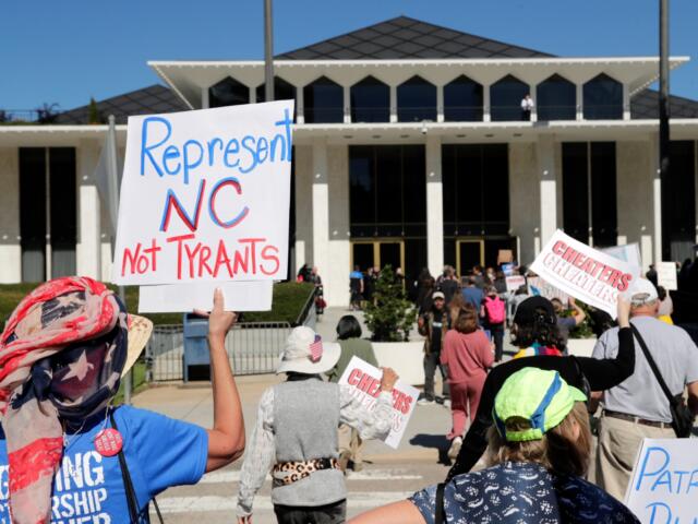 FILE - Demonstrators approach the Legislative Building during a rally protesting a proposed election redistricting map, Oct. 21, 2025, in Raleigh, N.C. (AP Photo/Chris Seward, File)