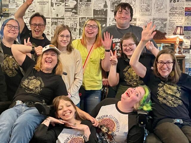 The staff of Madam Clutterbucket's Neurodiverse Universe pose for a picture.