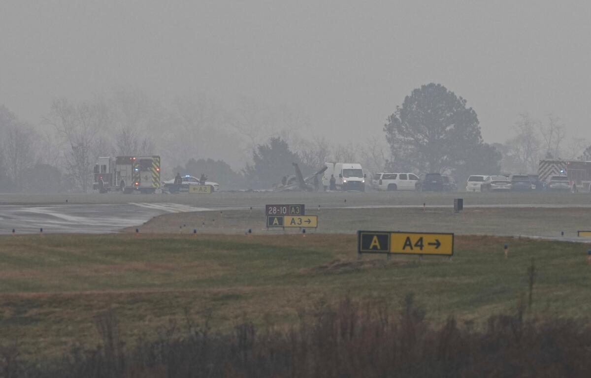First responders tend to the scene of a reported plane crash at a regional airport in Statesville, N.C., Thursday, Dec. 18, 2025. (AP Photo/Matt Kelley)