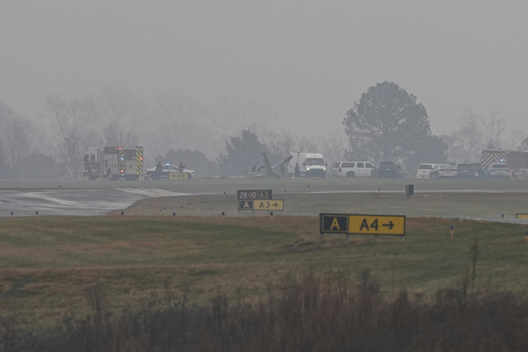 First responders tend to the scene of a reported plane crash at a regional airport in Statesville, N.C., Thursday, Dec. 18, 2025. (AP Photo/Matt Kelley)