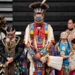 FILE - Members of the Lumbee Tribe bow their heads in prayer during the BraveNation Powwow and Gather at UNC Pembroke, March 22, 2025, in Pembroke, N.C. (AP Photo/Allison Joyce, file)