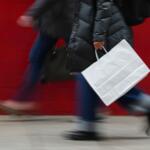 FILE - A person carries a shopping bag in Philadelphia, Dec. 10, 2025. (AP Photo/Matt Rourke, File)
