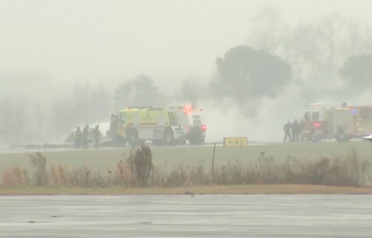 This screengrab made from video provided by WSOC shows firefighting crews responding to a reported plane crash at a regional airport in Statesville, N.C., erupting in a large fire, Thursday, Dec. 18, 2025. (WSOC via AP)