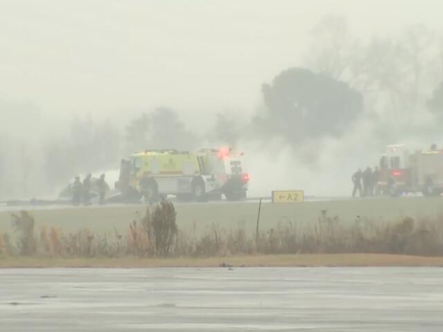 This screengrab made from video provided by WSOC shows firefighting crews responding to a reported plane crash at a regional airport in Statesville, N.C., erupting in a large fire, Thursday, Dec. 18, 2025. (WSOC via AP)