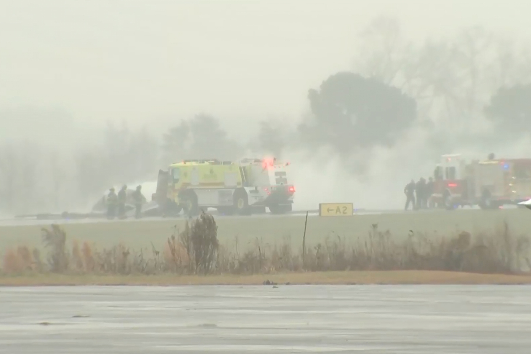 This screengrab made from video provided by WSOC shows firefighting crews responding to a reported plane crash at a regional airport in Statesville, N.C., erupting in a large fire, Thursday, Dec. 18, 2025. (WSOC via AP)