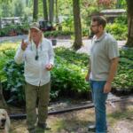 Botanical Treasures owner Robert Stine (left) speaks with Blue Ridge Community College’s Small Business Center Director Ben Smith (right) several months after Hurricane Helene.