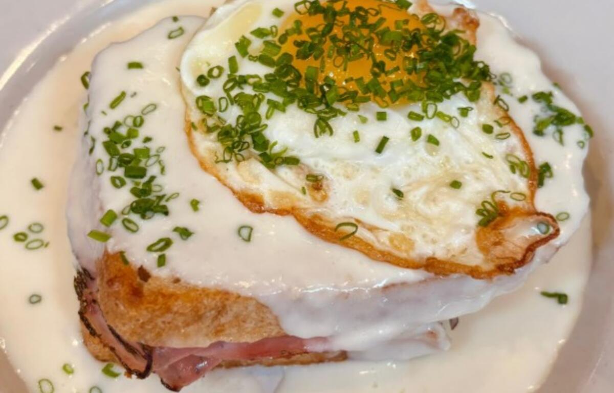 Croque Madame, a traditional sandwich of ham, gruyere cheese and Mornay sauce with an egg on top
