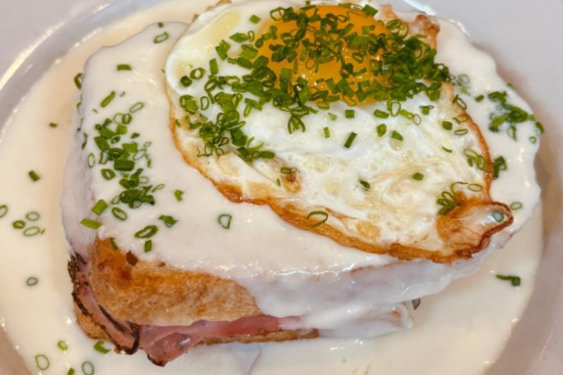 Croque Madame, a traditional sandwich of ham, gruyere cheese and Mornay sauce with an egg on top