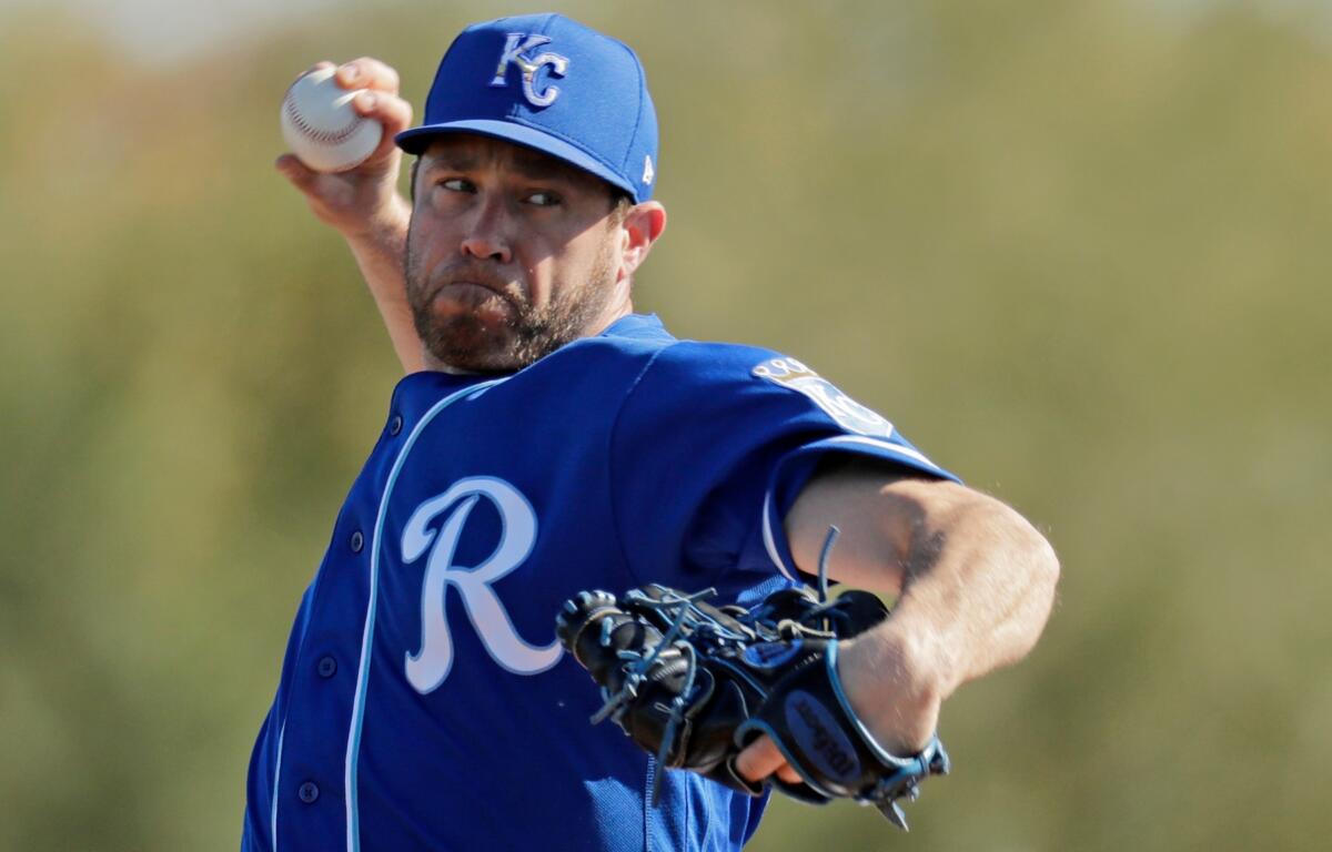 Kansas City Royals pitcher Greg Holland throws during spring training baseball practice Sunday, Feb. 16, 2020, in Surprise, Ariz. (AP Photo/Charlie Riedel)
