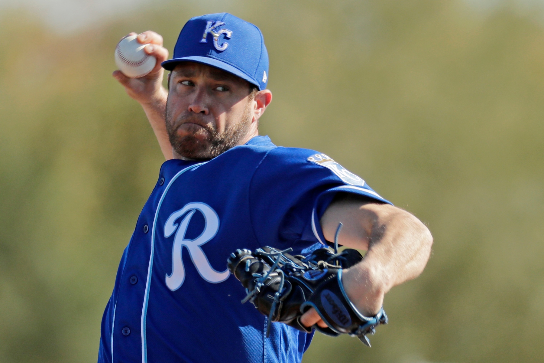 Kansas City Royals pitcher Greg Holland throws during spring training baseball practice Sunday, Feb. 16, 2020, in Surprise, Ariz. (AP Photo/Charlie Riedel)