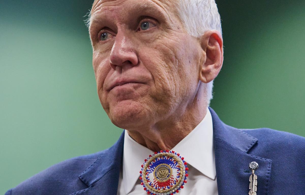 FILE - Wearing a beaded bolo around a pin that says "United States Senate," Sen. Thom Tillis, R-N.C., listens to thanks from members of the Lumbee Tribe of North Carolina, after the passage of a bill granting the tribe with federal recognition, on Capitol Hill, in Washington, Dec. 17, 2025. (AP Photo/Jacquelyn Martin, File)