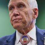 FILE - Wearing a beaded bolo around a pin that says "United States Senate," Sen. Thom Tillis, R-N.C., listens to thanks from members of the Lumbee Tribe of North Carolina, after the passage of a bill granting the tribe with federal recognition, on Capitol Hill, in Washington, Dec. 17, 2025. (AP Photo/Jacquelyn Martin, File)