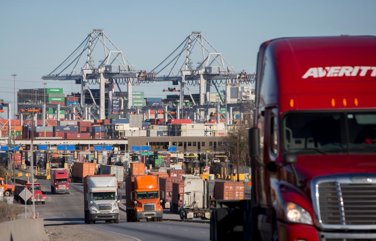 FILE- Tractor-trailers move cargo out of the Port of Savannah in Savannah, Ga., Jan. 30, 2018. (AP Photo/Stephen B. Morton, File)