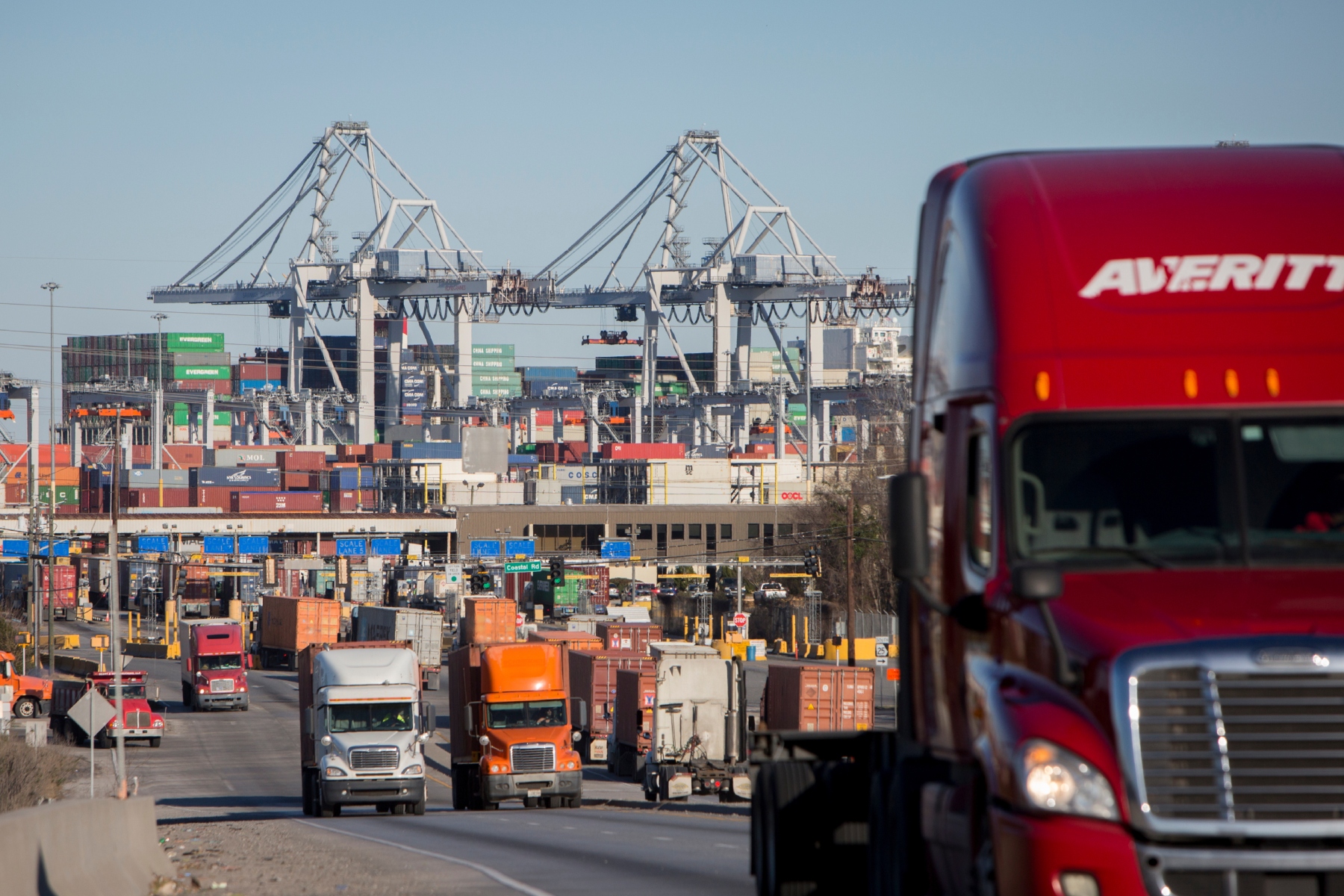 FILE- Tractor-trailers move cargo out of the Port of Savannah in Savannah, Ga., Jan. 30, 2018. (AP Photo/Stephen B. Morton, File)