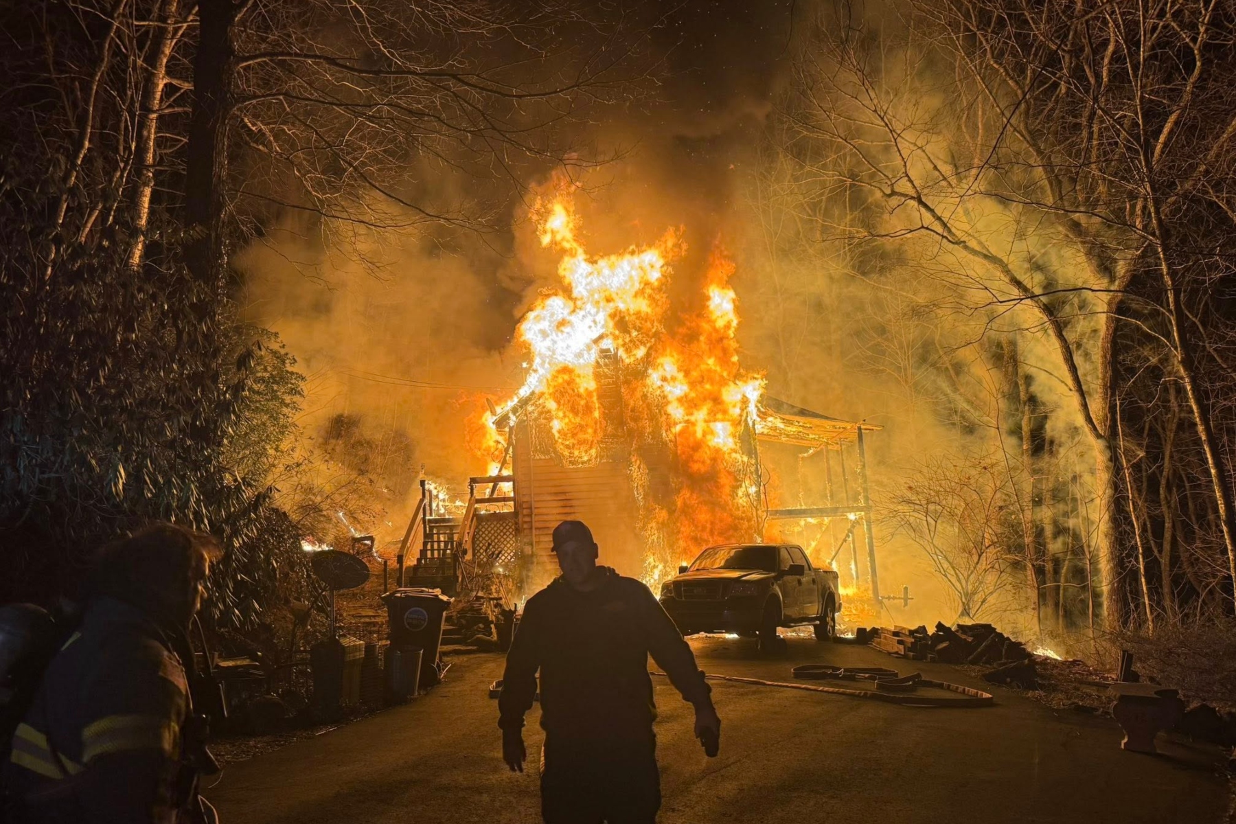 A late-night house fire in Fairview destroyed a home and spread into nearby woods, Fairview Volunteer Fire Department officials said.
