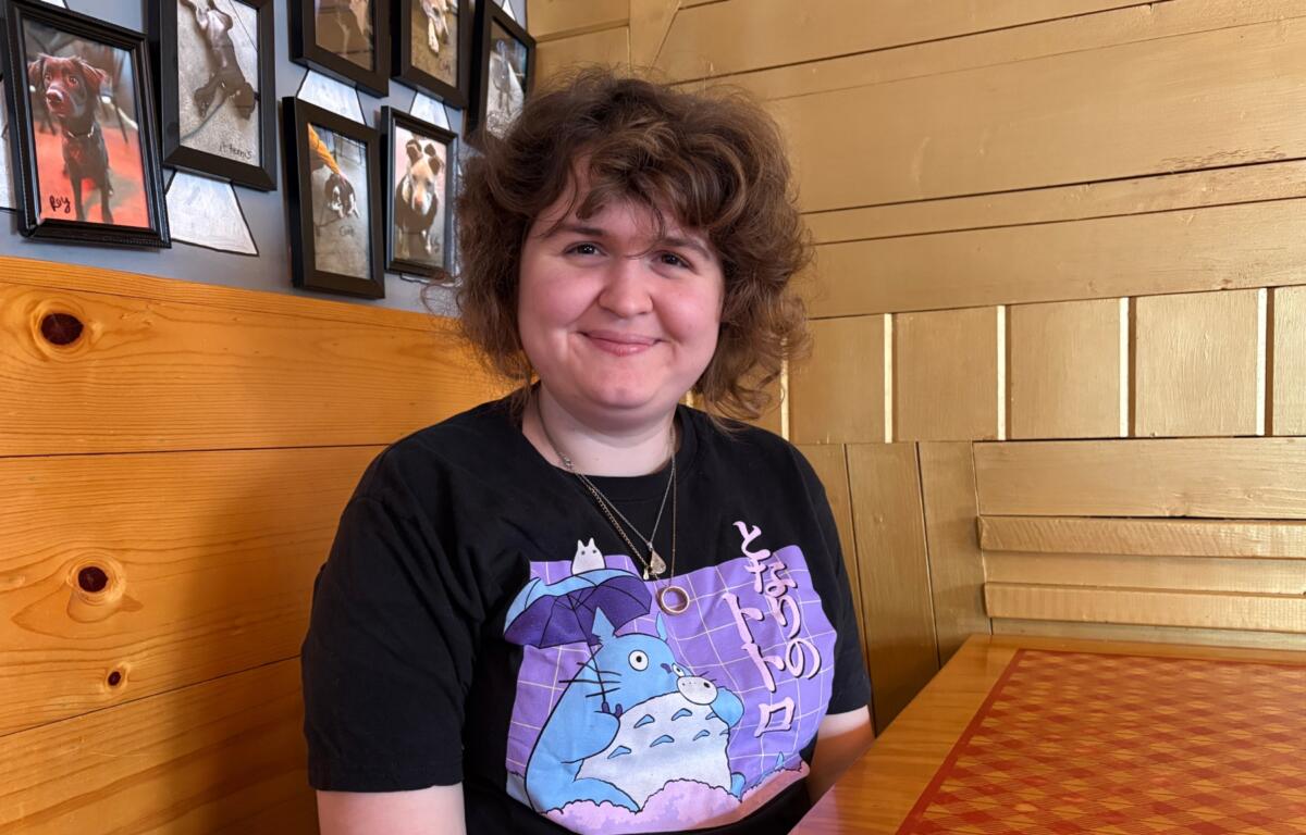 Maddie Hayler, a senior at UNC Asheville, delivers food and checks on customers at Pizza Mind.