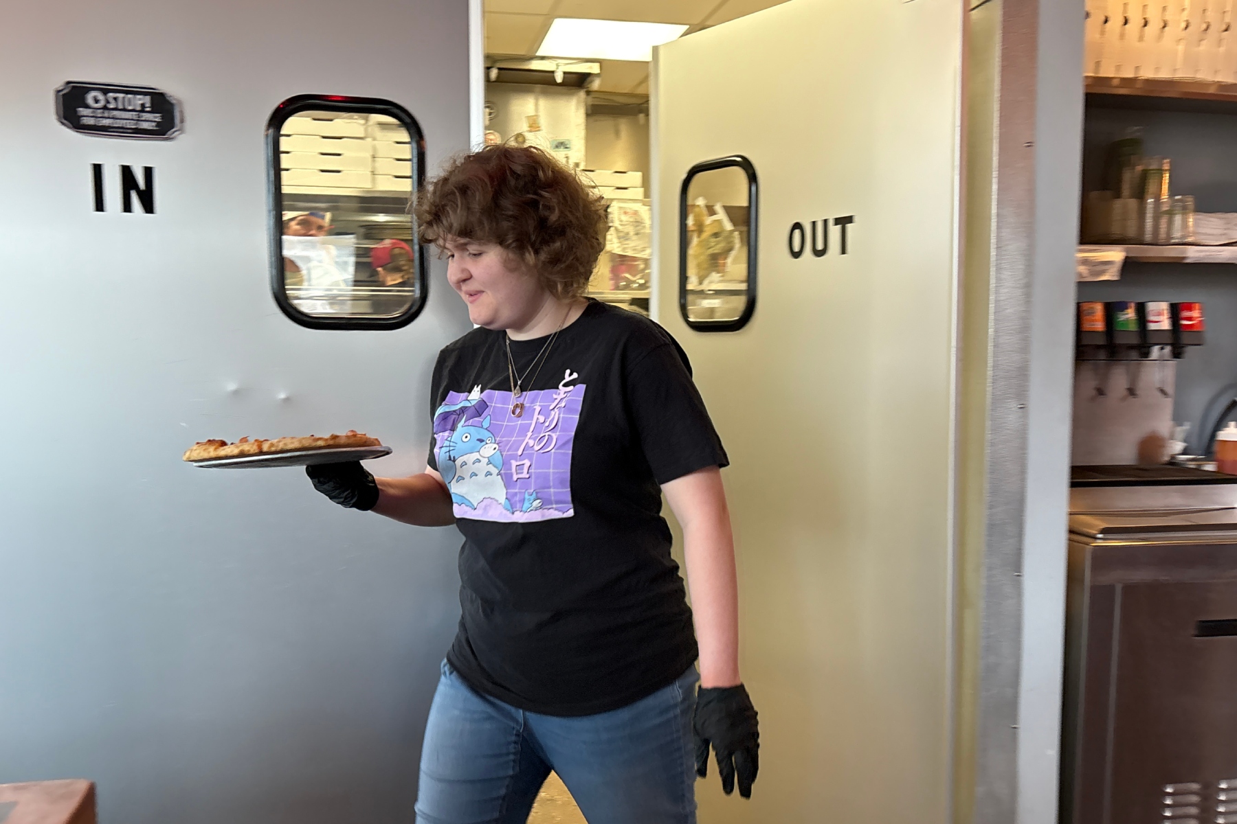 Maddie Hayler, a senior at UNC Asheville, delivers food and checks on customers at Pizza Mind.