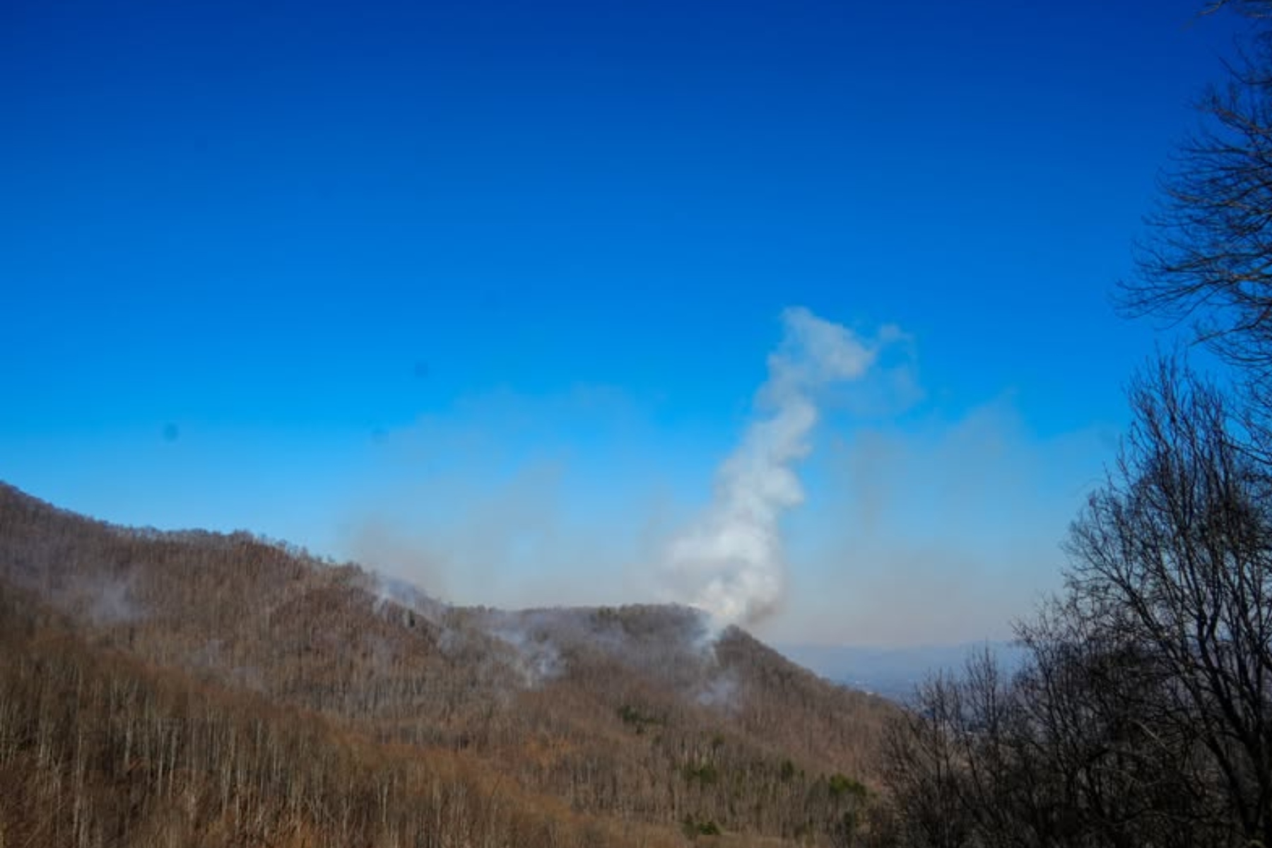 A smoke column was visible south of the Winding Stairs area, according to a USDA Forest Service photo released Monday.