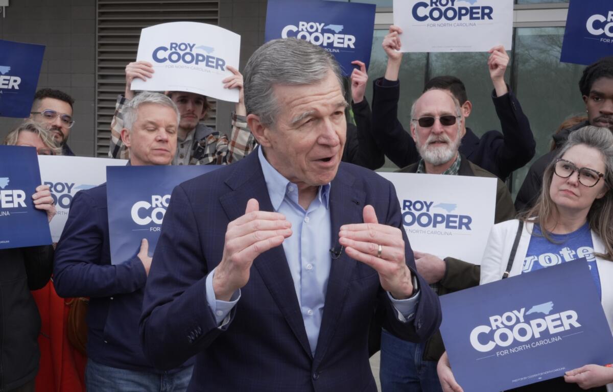 Democratic former Gov. Roy Cooper, who is running for U.S. Senate, speaks to reporters after casting his ballot on the first day of in-person early voting in the state's primary election, Thursday, Feb. 12, 2026, in Raleigh, N.C. (AP Photo/Allen G. Breed)