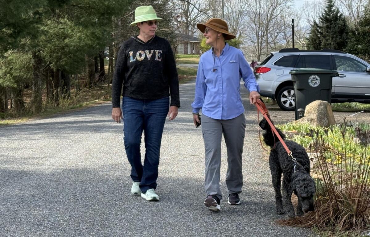Mary and Deb Love walk their dog Hugo.