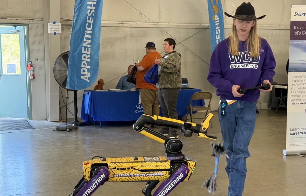 Western Carolina University student Tanner Drum demonstrated a robotic dog used on job sites. The Boston Dynamics “Spot” robot -- nicknamed “Catabox” -- can perform automated site walks, capture images, scan environments using lidar and generate 3D models.