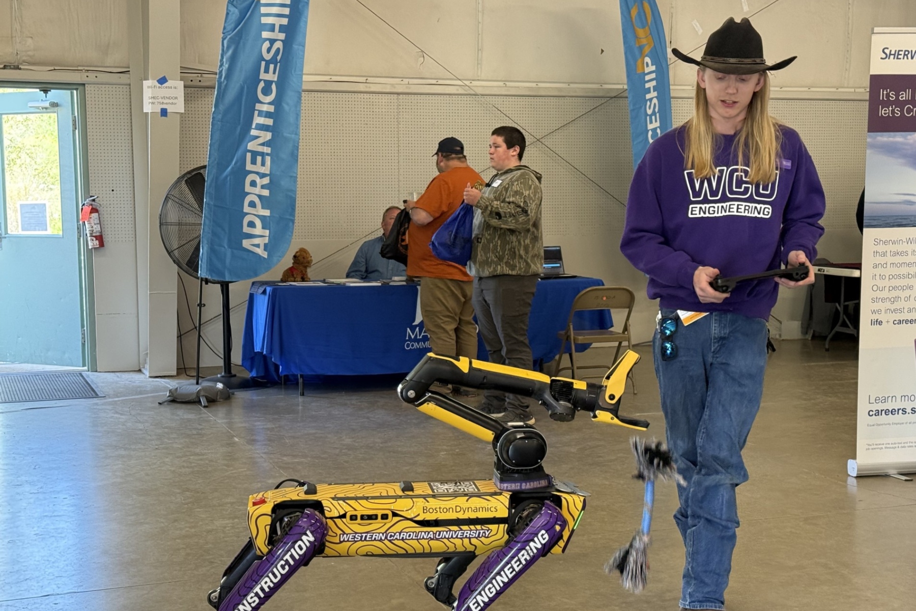 Western Carolina University student Tanner Drum demonstrated a robotic dog used on job sites. The Boston Dynamics “Spot” robot -- nicknamed “Catabox” -- can perform automated site walks, capture images, scan environments using lidar and generate 3D models.