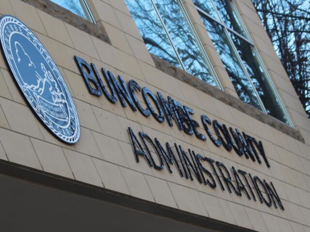 Facade of a government building showing the 'BUNGOMA COUNTY ADMINISTRATION' sign and a blue circular seal on a beige tiled wall.