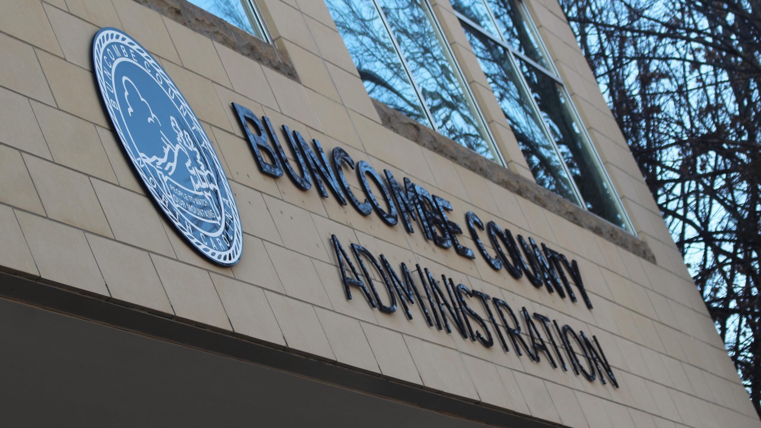Facade of a government building showing the 'BUNGOMA COUNTY ADMINISTRATION' sign and a blue circular seal on a beige tiled wall.