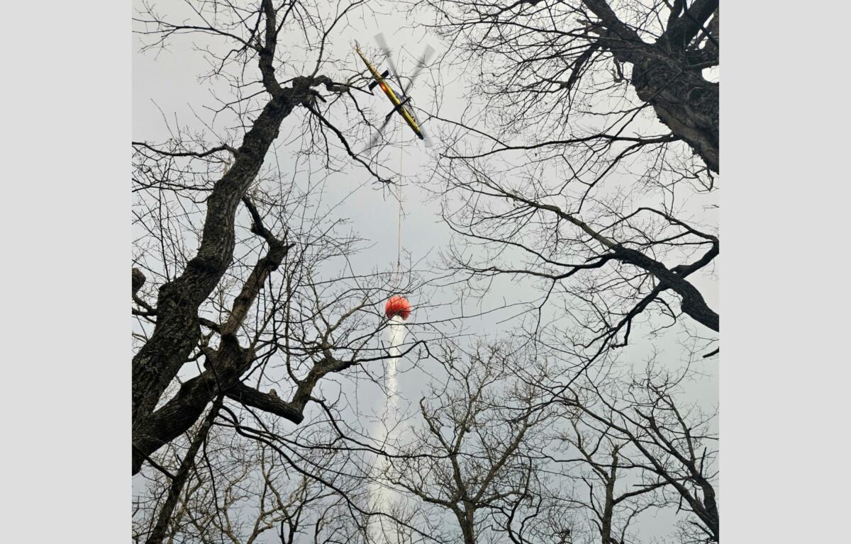 Helicopter making a water bucket drop on the Kitsuma Fire. (Photo credit: U.S. Forest Service/Matt Switzer)