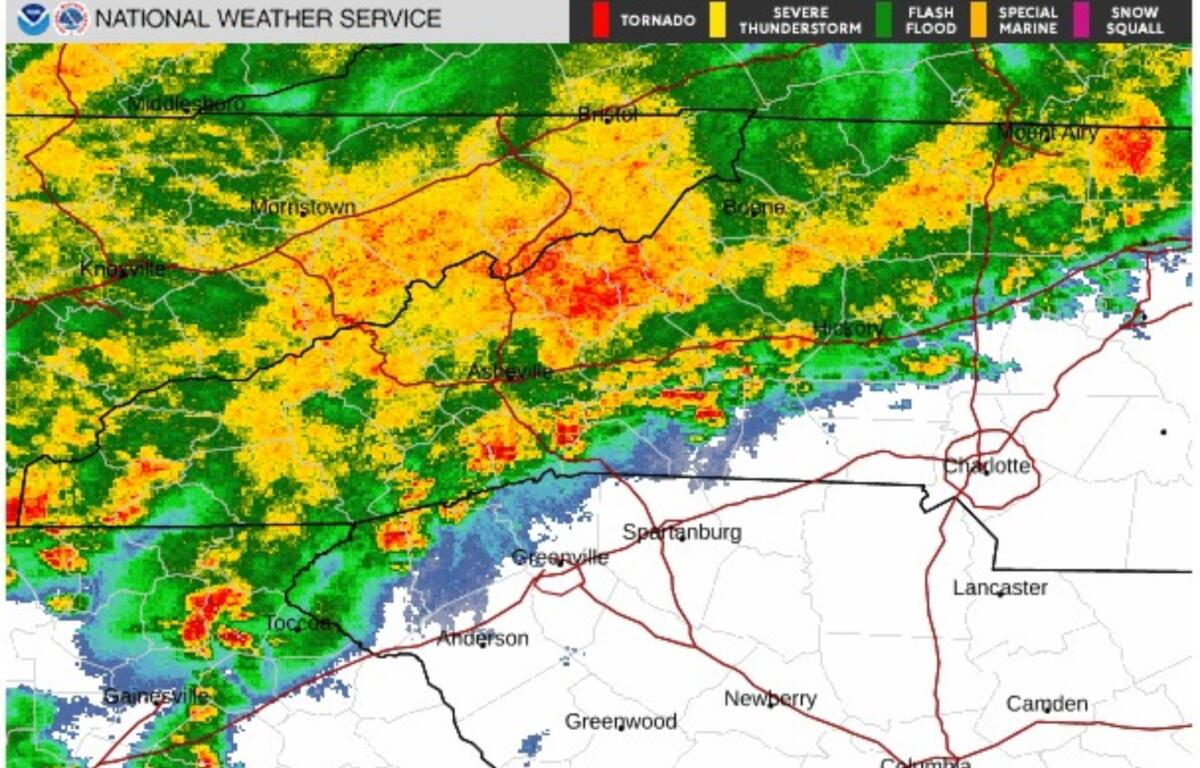 NWS radar map showing a broad band of rainfall from green to red moving across western North Carolina and eastern Tennessee, with cities like Knoxville, Morristown, Asheville and Charlotte nearby.