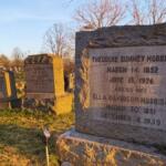 Granite grave marker in a sunny cemetery, reads Theodore Sum­mey Morrison (1852–1926) and Ella Davidson Morrison (1851–1939) with other worn headstones nearby.