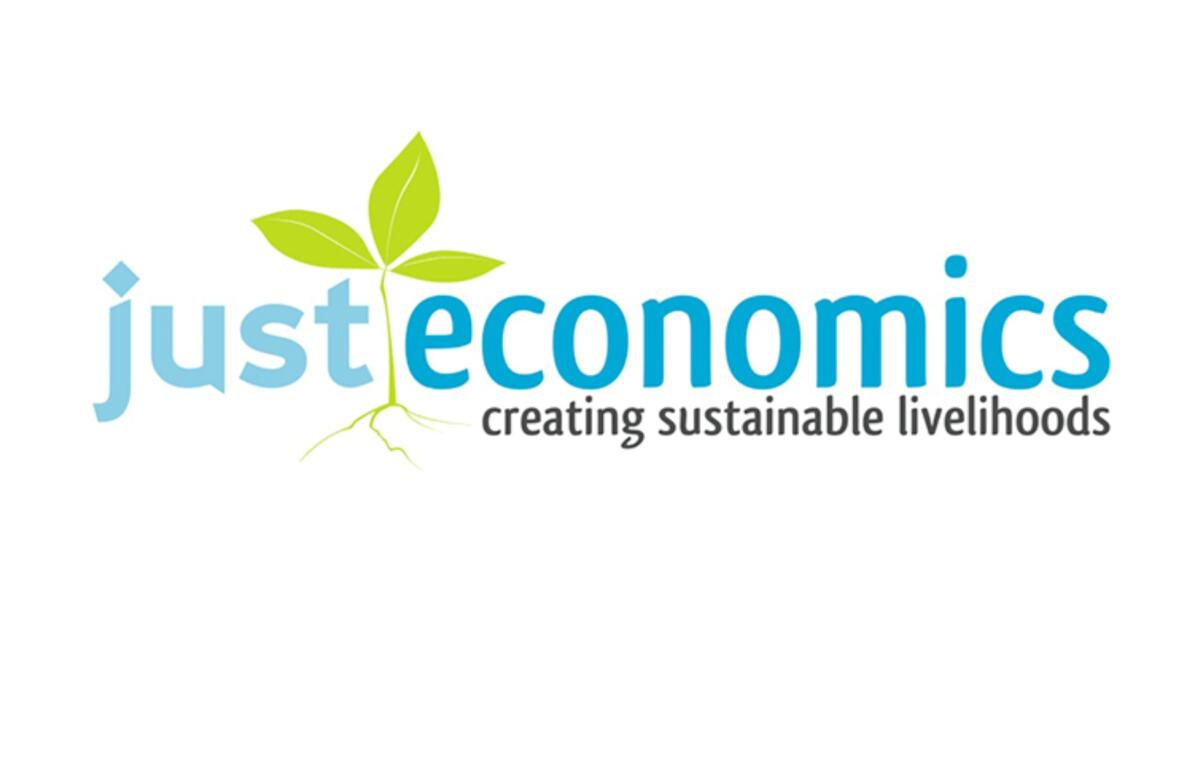 Just Economics logo featuring a green sprout and the tagline creating sustainable livelihoods.