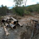 The remnants of a waterline serving Asheville, N.C., is piled up downstream from North Fork Reservoir, a main source of water for the city, Wednesday, Oct. 2, 2024, after the line was destroyed during Hurricane Helene in Black Mountain, N.C. (AP Photo/Jeff Roberson)