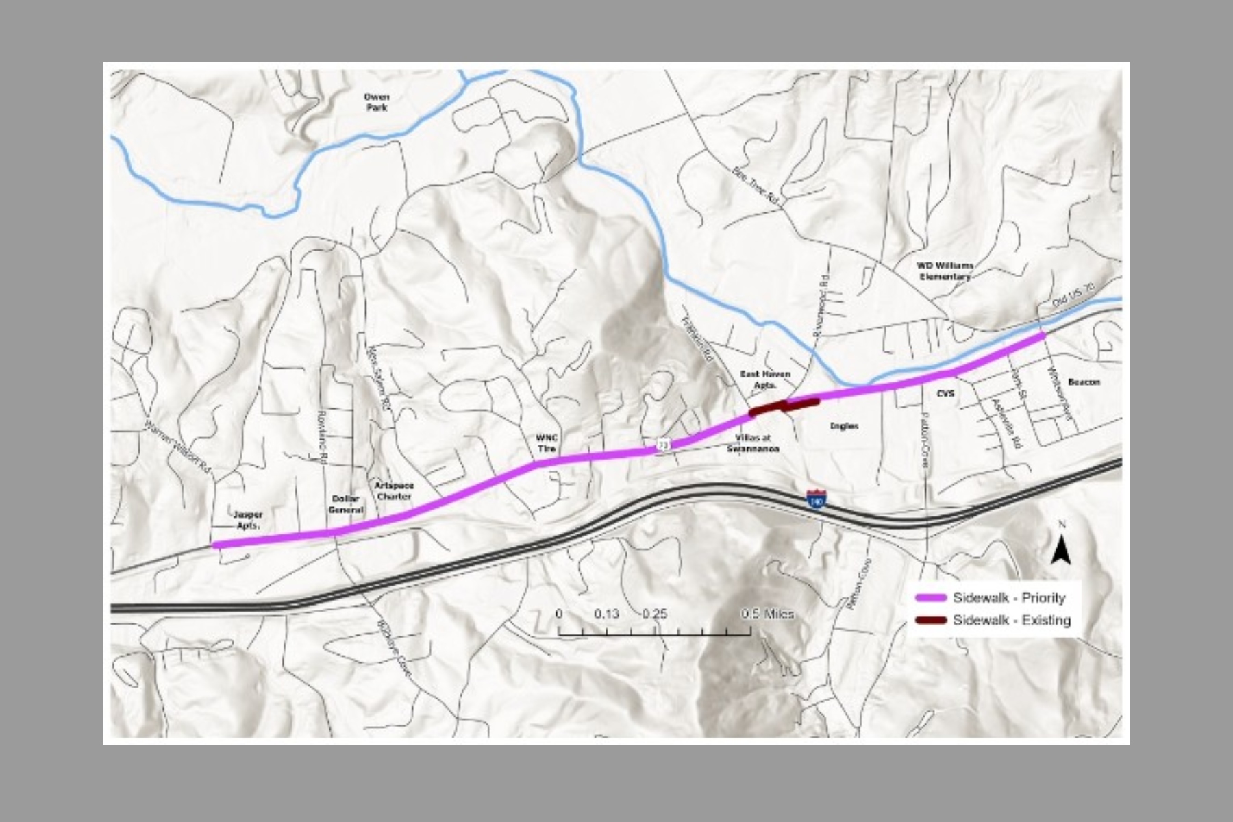 Map of a town showing a proposed sidewalk route in purple (priority) along a highway, with an existing sidewalk in maroon and blue water features nearby.