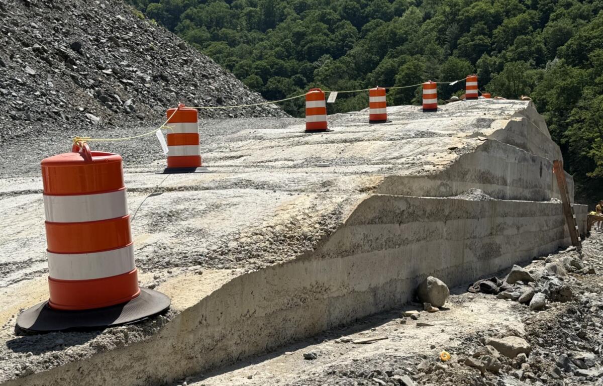 A section of roller-compacted concrete, or RCC, takes shape along Interstate 40 in the Pigeon River Gorge.