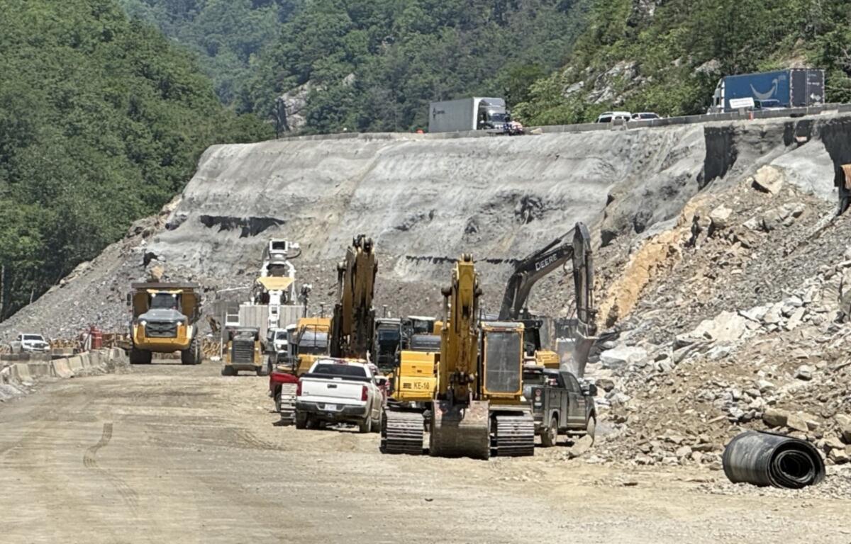 Traffic moves slowly above an active construction work zone on Interstate 40 near the Pigeon River Gorge, where holiday travel, ongoing repairs and reduced speeds can combine to create backups during peak periods.