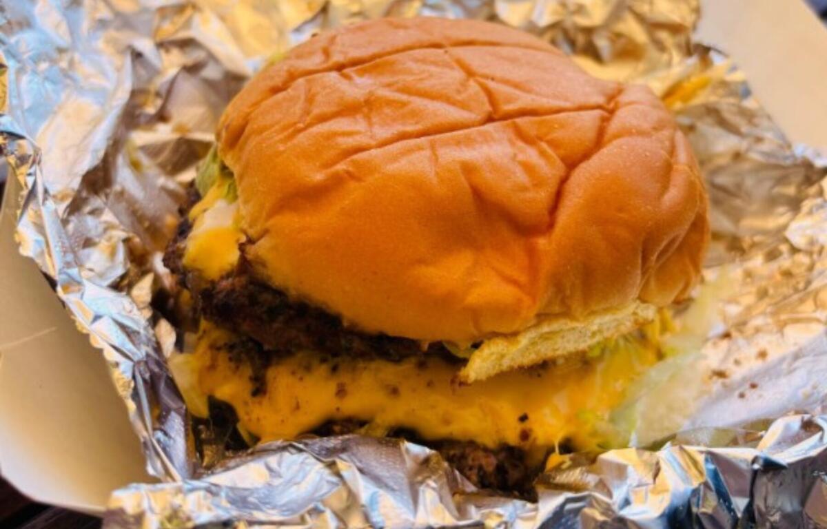 A brisket burger and brisket-loaded queso with chips at Iron & Oak in Woodfin deliver a rich, smoky and gloriously messy barbecue experience packed with indulgent flavor.