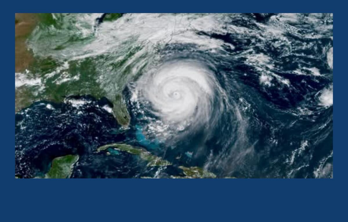Satellite view of a powerful hurricane with a clear eye, spinning over the western Caribbean near Cuba and the surrounding ocean.