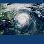 Satellite view of a powerful hurricane with a clear eye, spinning over the western Caribbean near Cuba and the surrounding ocean.