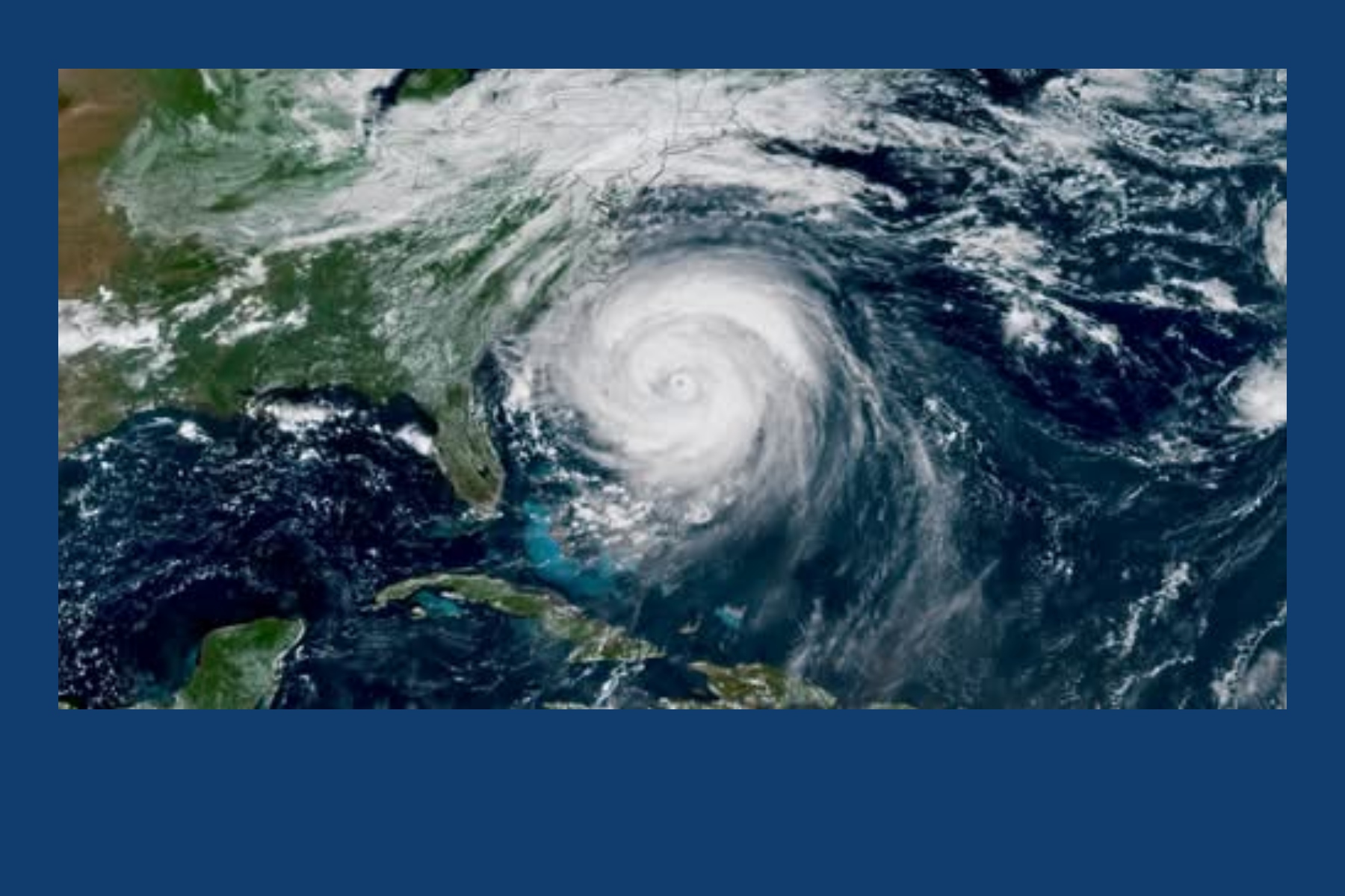 Satellite view of a powerful hurricane with a clear eye, spinning over the western Caribbean near Cuba and the surrounding ocean.