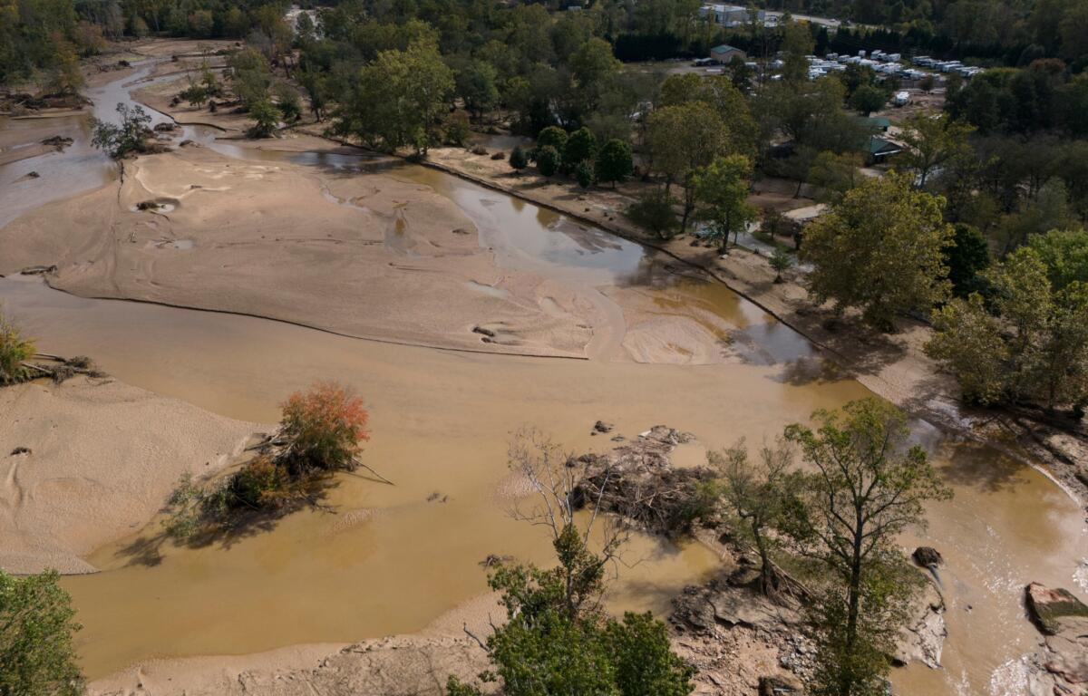 Water is seen outside the banks of the Swannanoa river in the aftermath of Hurricane Helene, Tuesday, Oct. 1, 2024, in Swannanoa, N.C. (AP Photo/Mike Stewart)