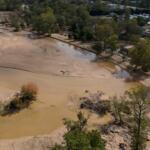 Water is seen outside the banks of the Swannanoa river in the aftermath of Hurricane Helene, Tuesday, Oct. 1, 2024, in Swannanoa, N.C. (AP Photo/Mike Stewart)